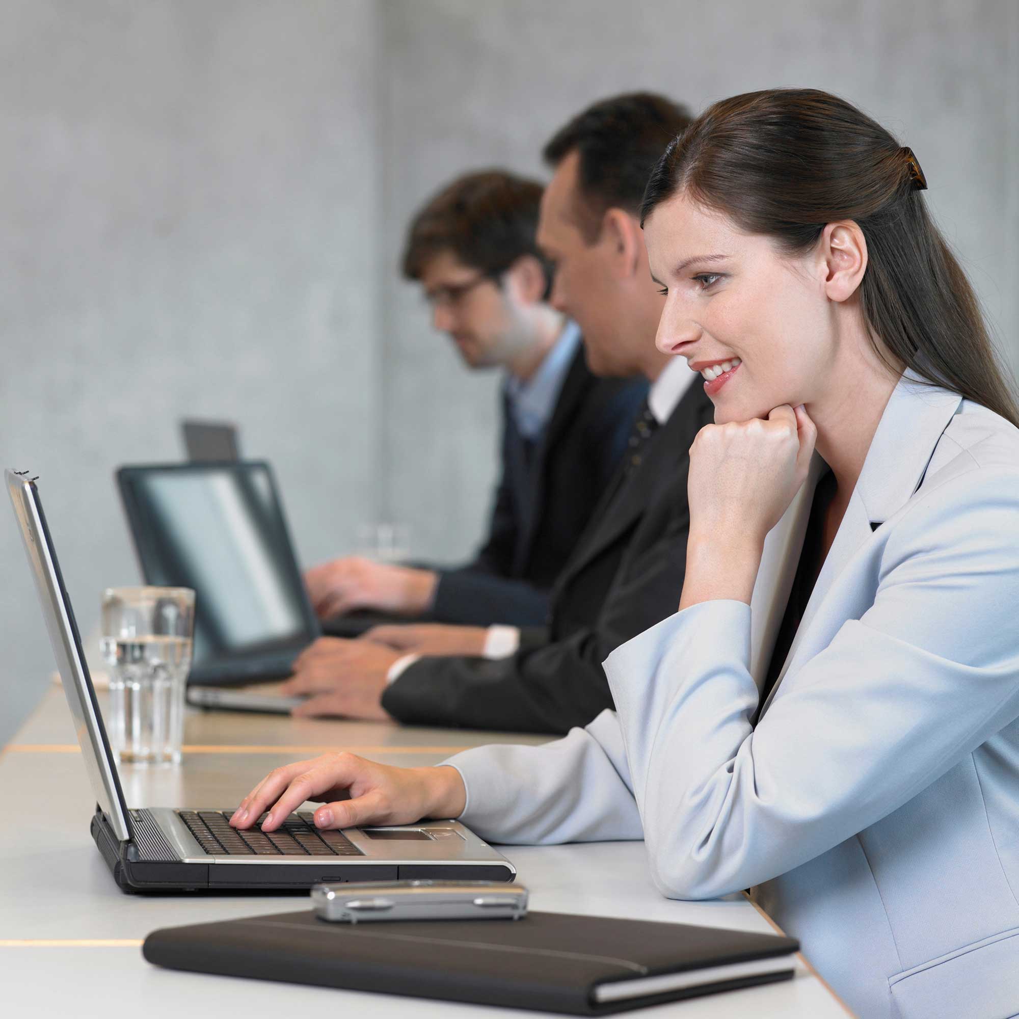 businesswoman-using-laptop-smiling-2022-03-08-00-21-51-utc.jpg