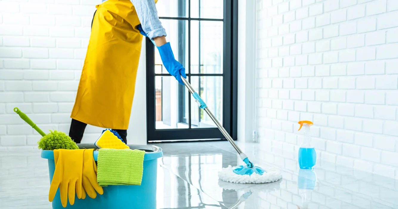 happy-young-woman-blue-rubber-using-mop-while-cleaning-floor-home.webp