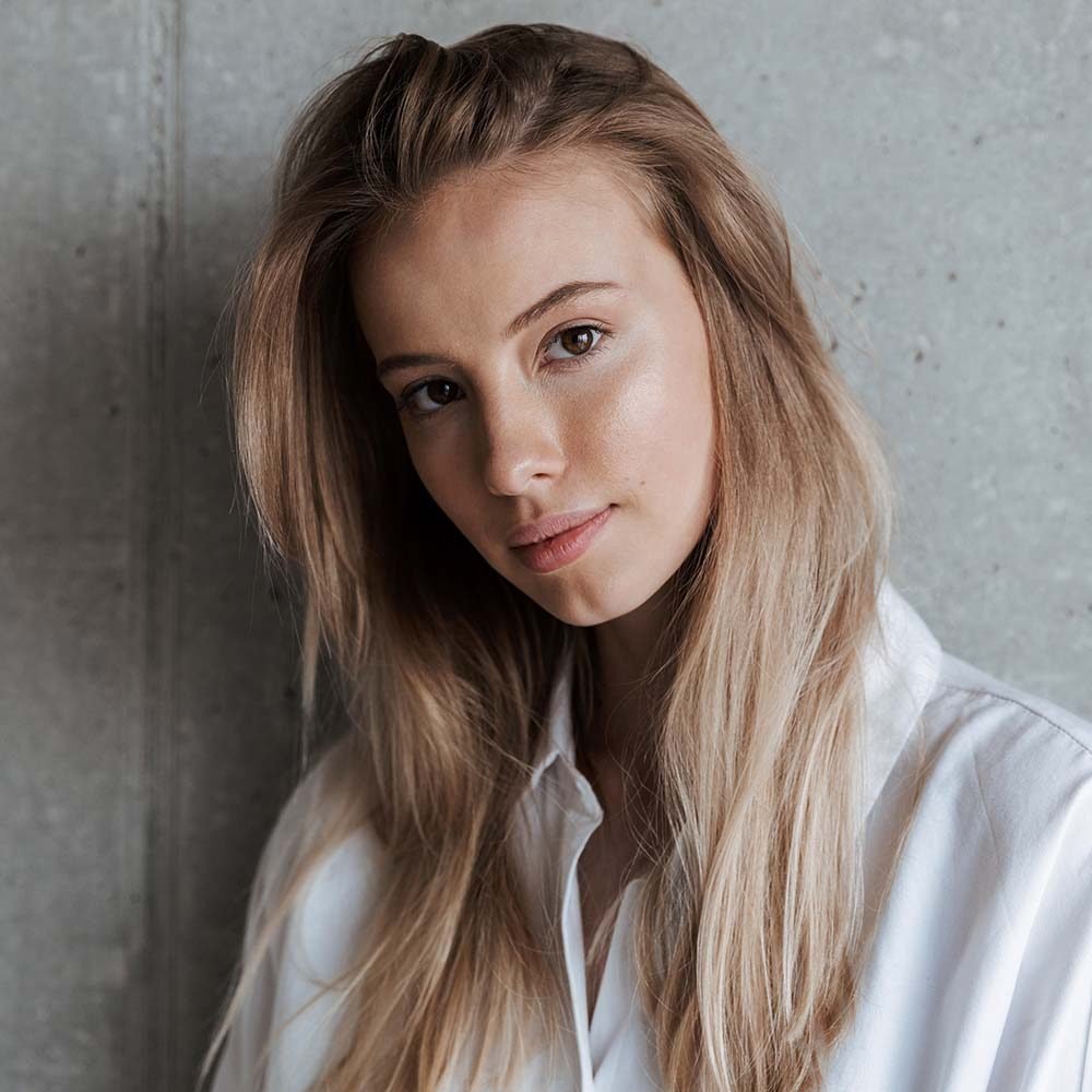 beautiful-young-woman-indoors-over-grey-wall-2J9FTBX.jpg